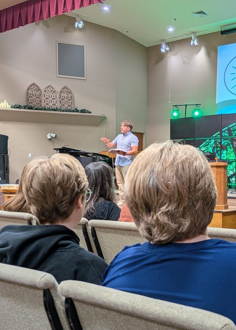 Christopher Wisener teaching from Scripture in a church gathering